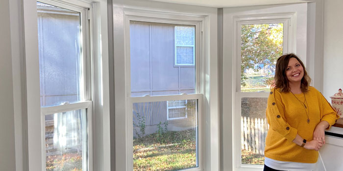 Window after with house owner posing next to windows.